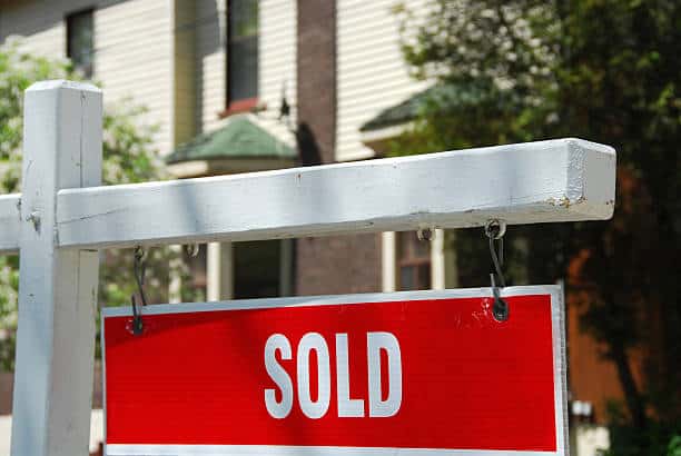 Closeup on sold sign near residential house